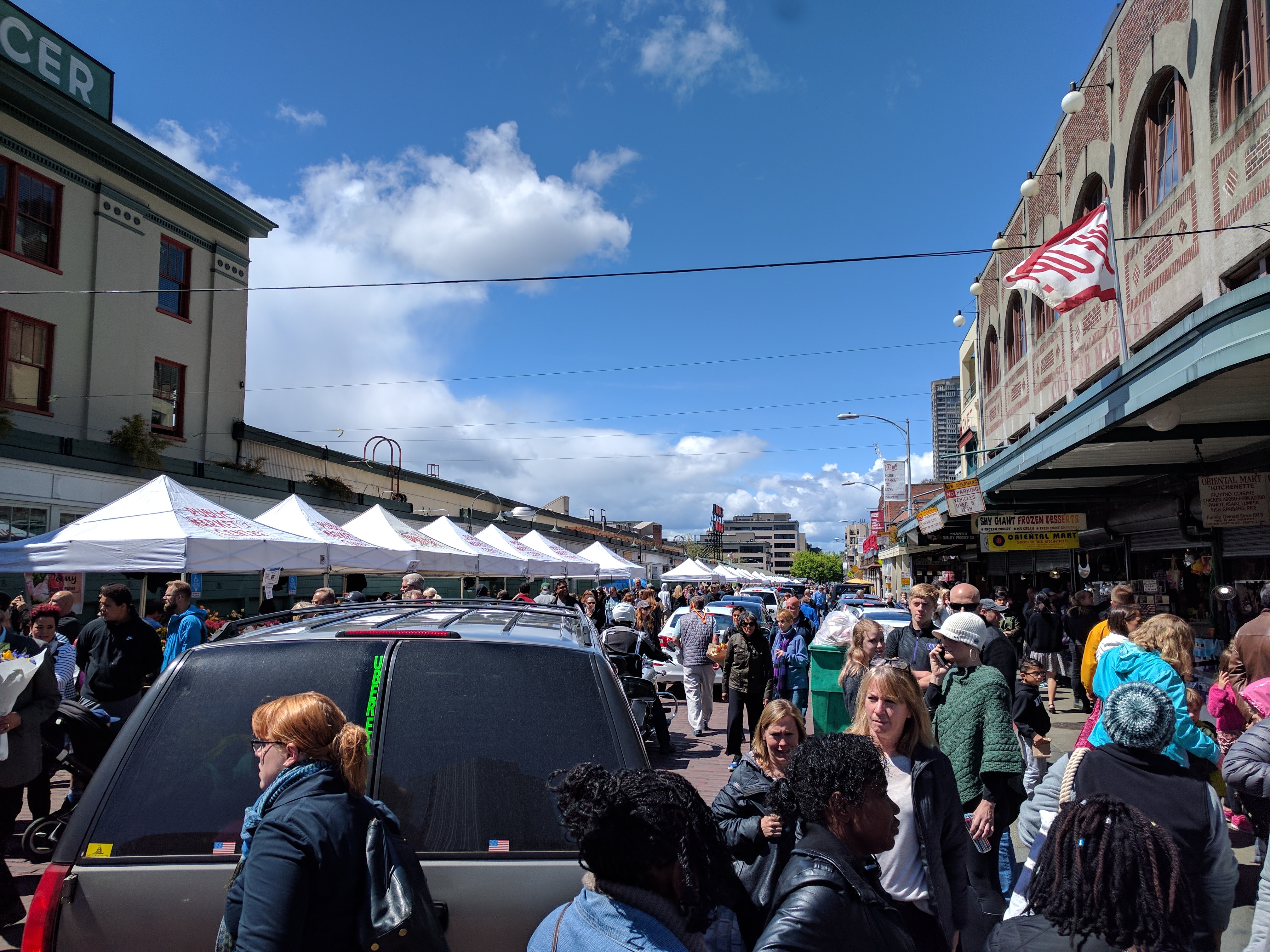 Uber Eats drives through a crowed at Pike Place Market